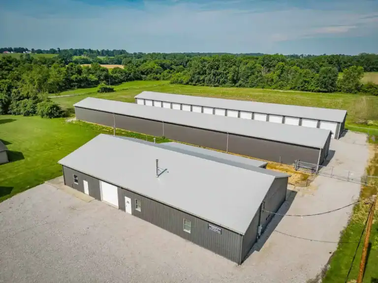 Drone view of Westerville Auto’s industrial-grade facility with multiple garage bays and red roof accents, situated along a major thoroughfare.