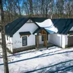 Aerial angle of the West Howard Residence highlighting the attached garage, gable rooflines, and detailed exterior finishes by Swiss Construction.