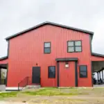 Two-story red metal Shooting Club building by Swiss Construction