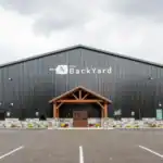 Exterior of The Backyard pole building with timber-framed entrance