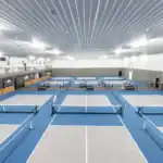 Rows of indoor pickleball courts inside The Backyard