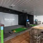 Indoor golf simulator bays at The Backyard